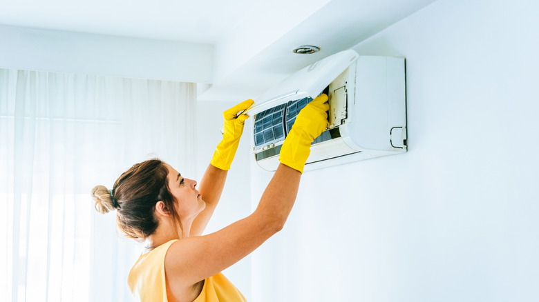 woman looking at AC unit