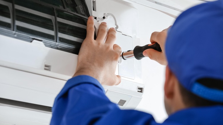 man fixing air conditioner