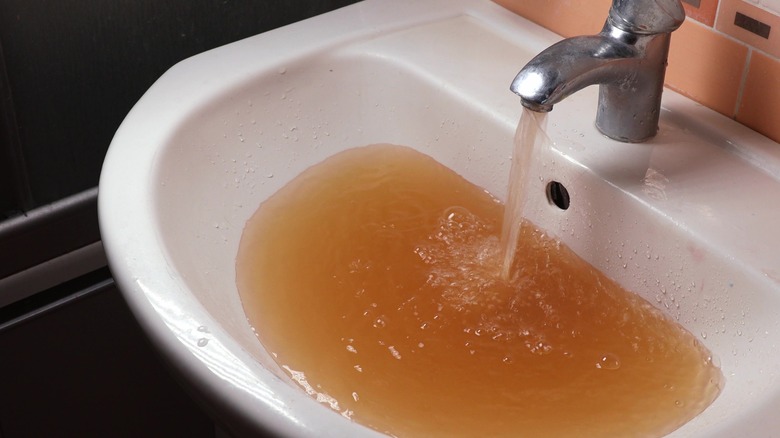 brown tap water in sink