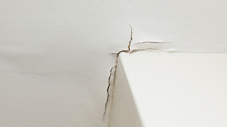 The wall is cracked near a corner.