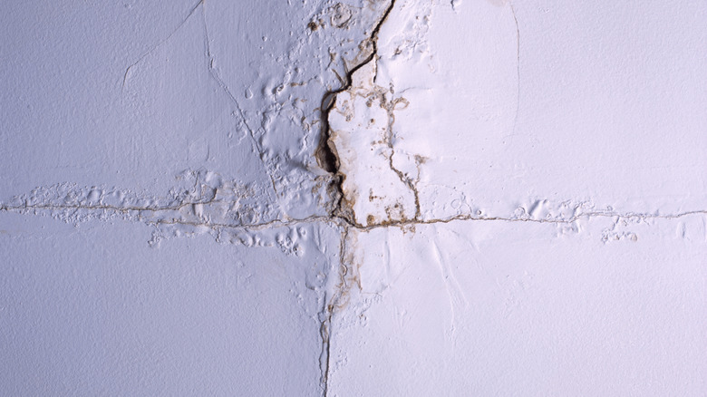 A sagging ceiling with a spiderweb crack.