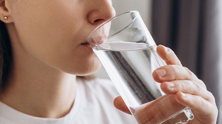 Woman drinking water out of a glass