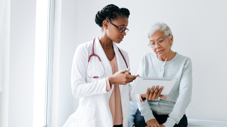 Woman doctor talking to patient