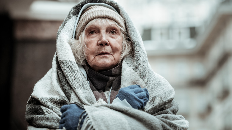 Older woman cold in the elements