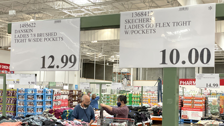 Two price labels at Costco, one with an asterisk and one without