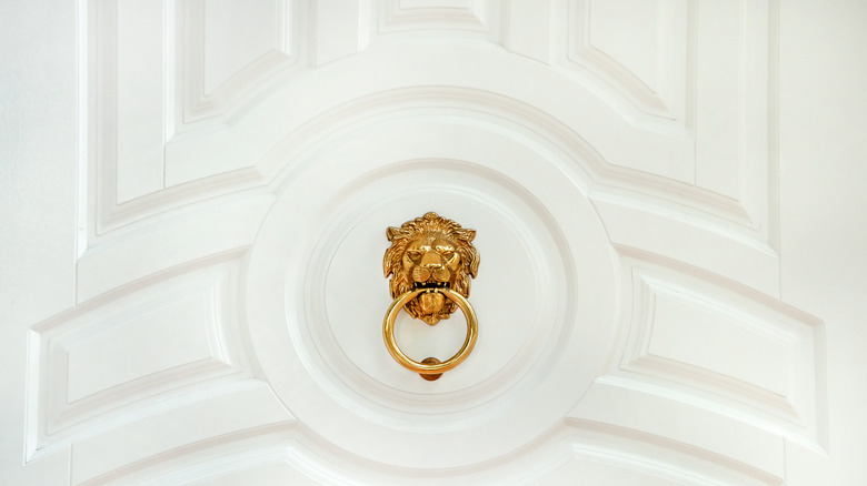 Gold door knocker with lion