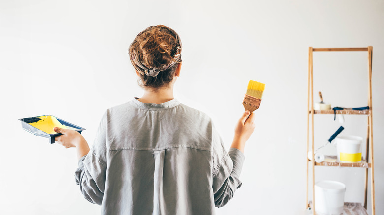 Woman painting wall