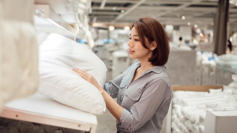 Woman looking at pillow