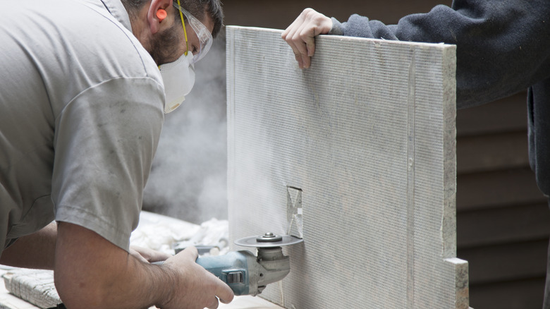 man working on grantite countertop