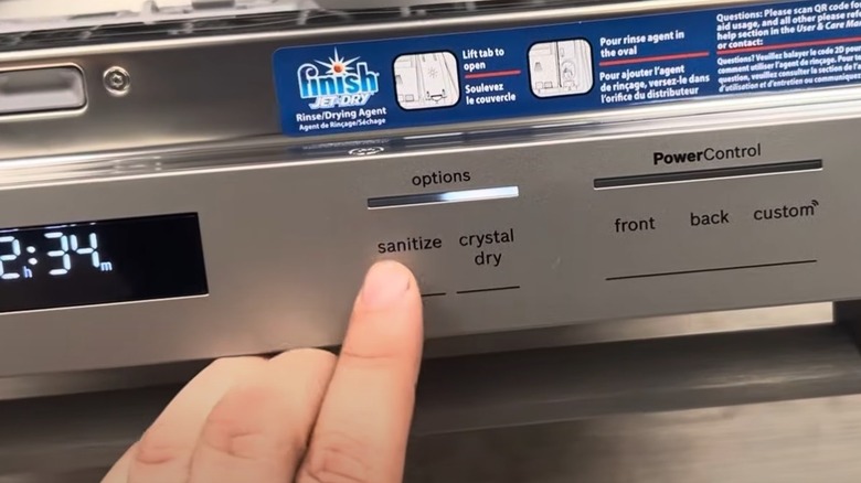 A person selecting the CrystalDry option on a Bosch dishwasher