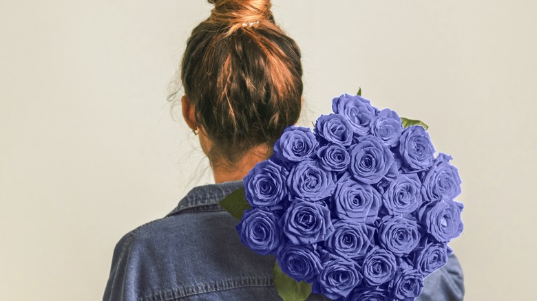 Woman holding purple roses