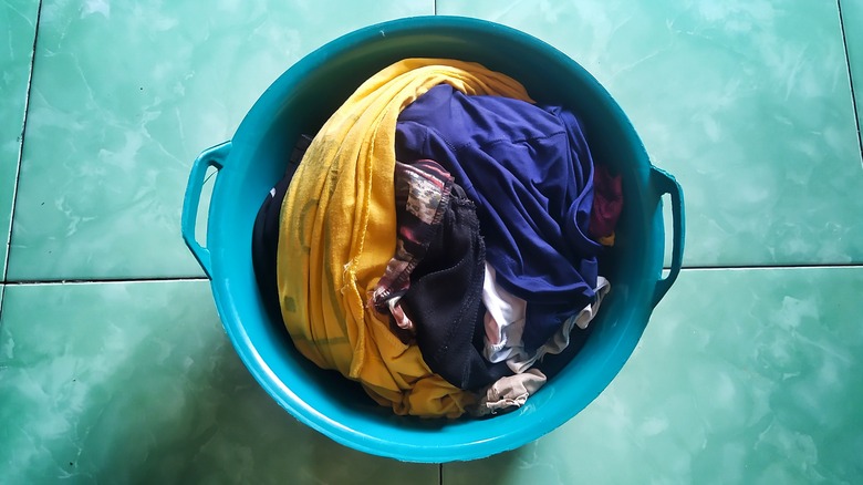 washed clothes in green bucket