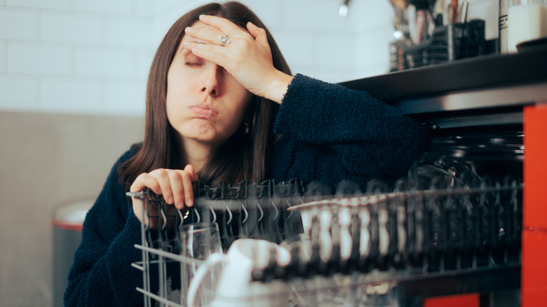 Unhappy woman dealing with a dishwasher error