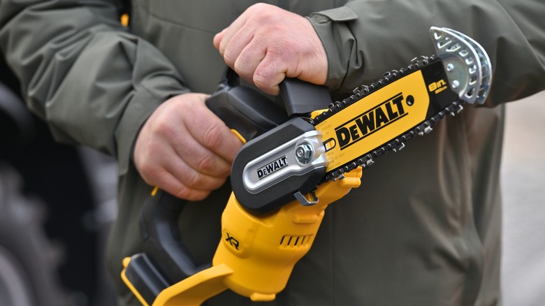 Person holding DeWalt power tool