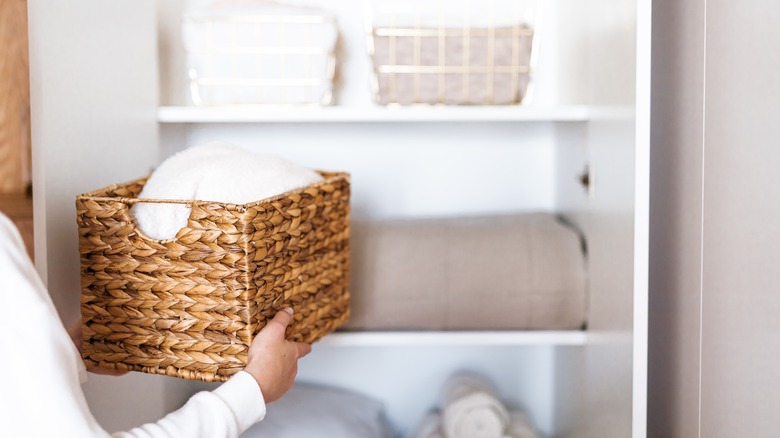 Person organizing linen closet