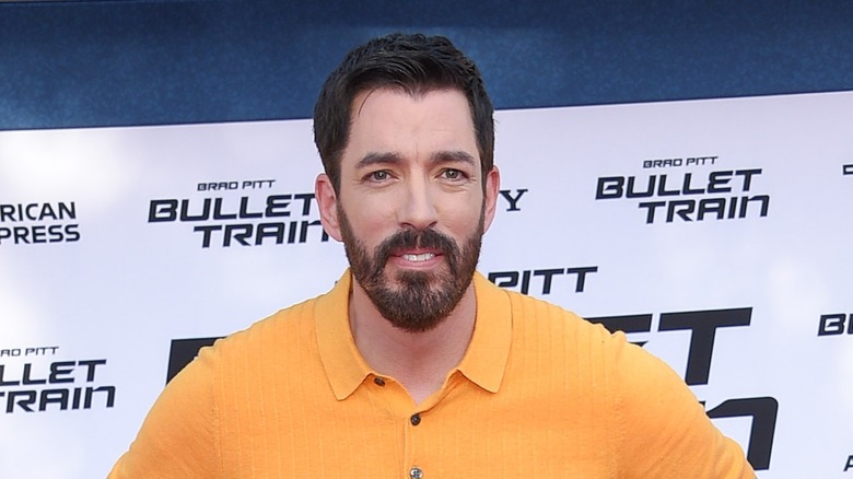 Drew Scott in orange shirt