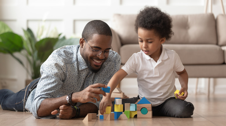 father and son playing with blocks