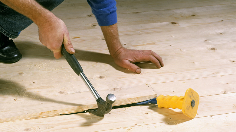 man removing floor 