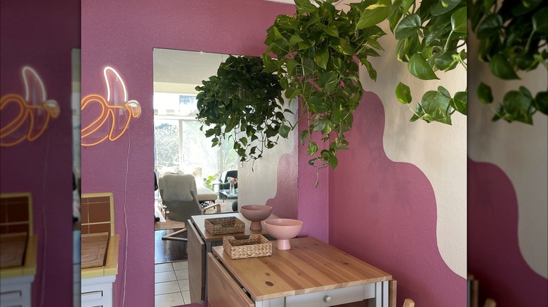 Purple painted dining nook with mirror