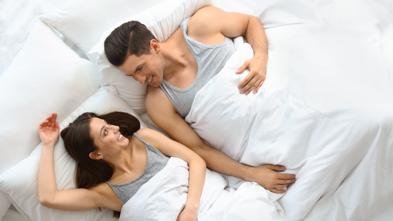 couple smiling in bed