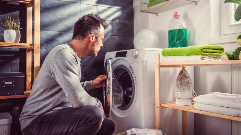 Man checks on laundry