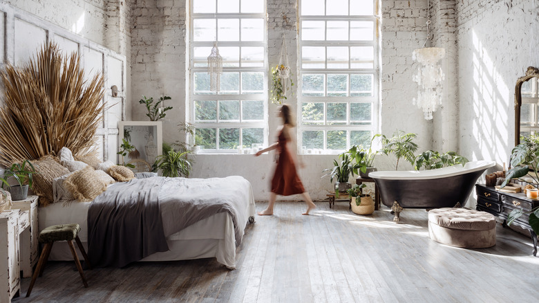 Woman walking in large bedroom