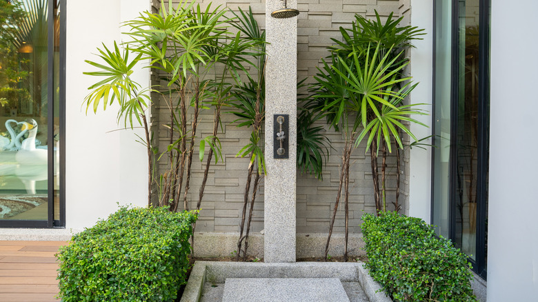 Concrete outdoor shower near house