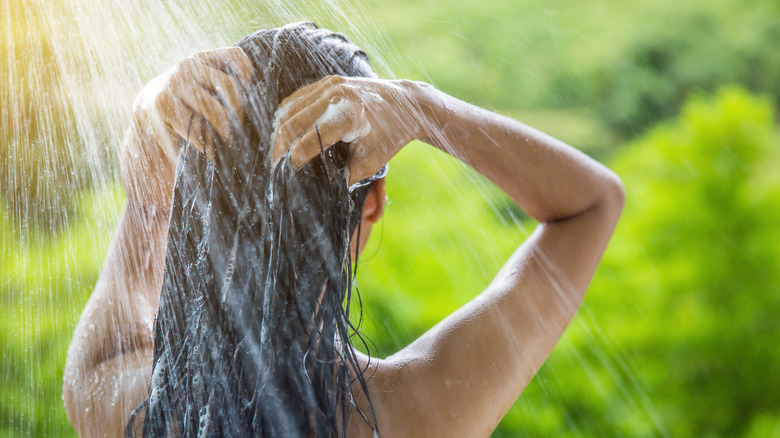 Woman washing hair from behind