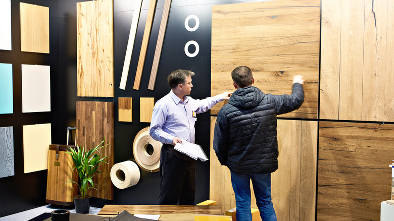 People looking at wooden panels