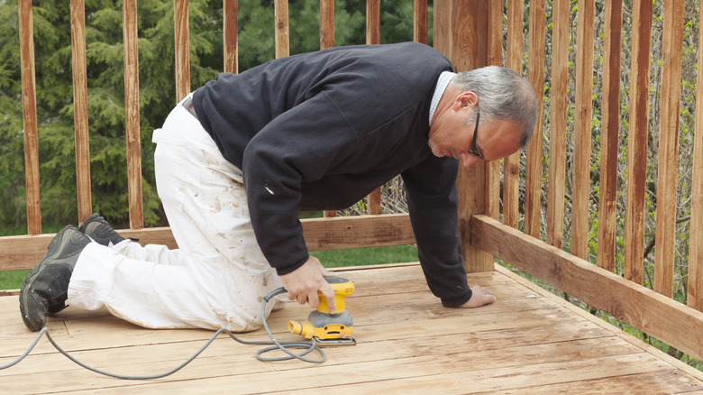 Person sanding the deck