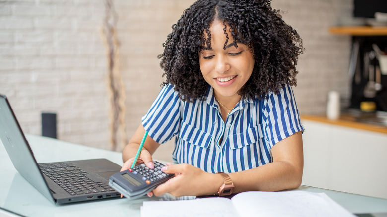 woman calculating costs online