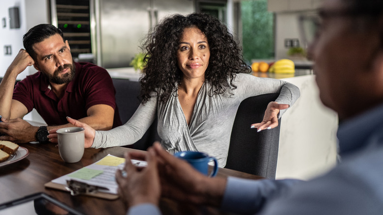 Couple talking with mortgage officer