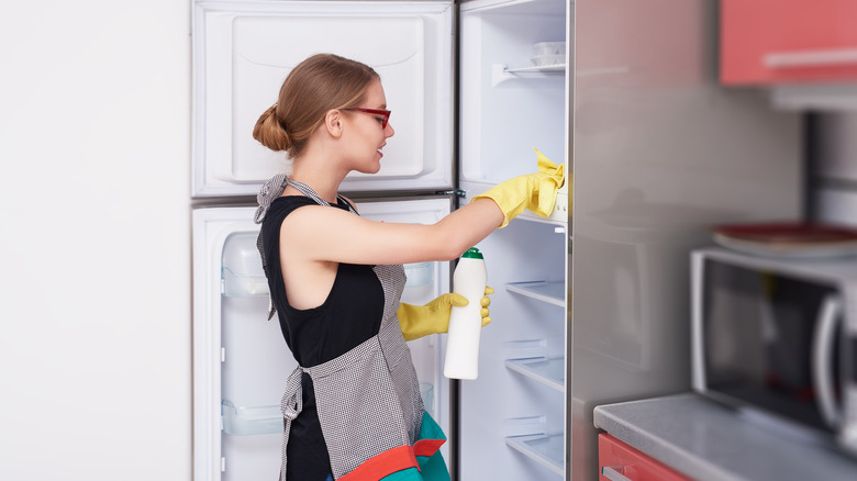 woman cleaning fridge