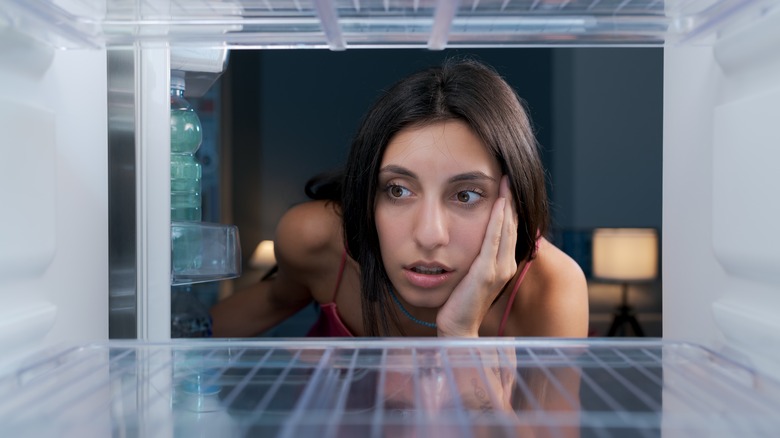 woman looking in fridge