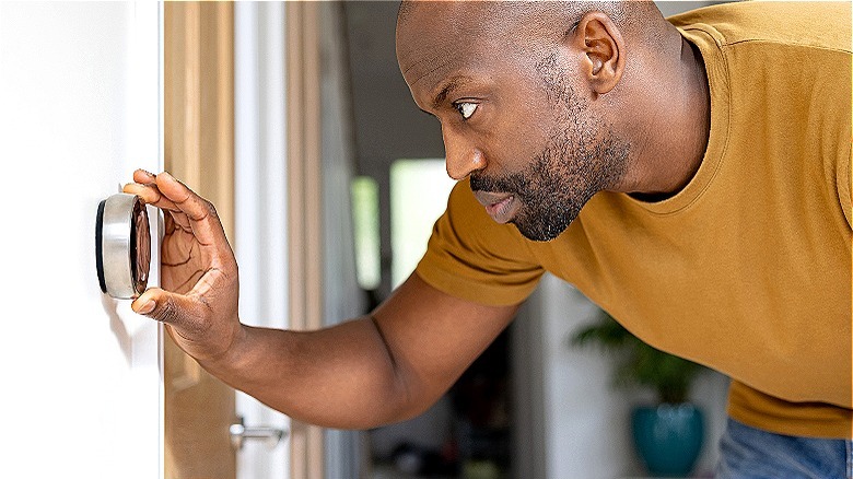 Person adjusting thermostat