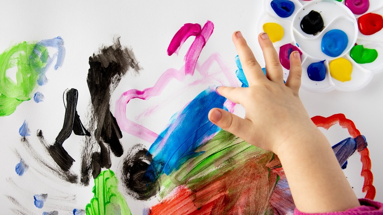 Child's messy fingers from fingerpainting