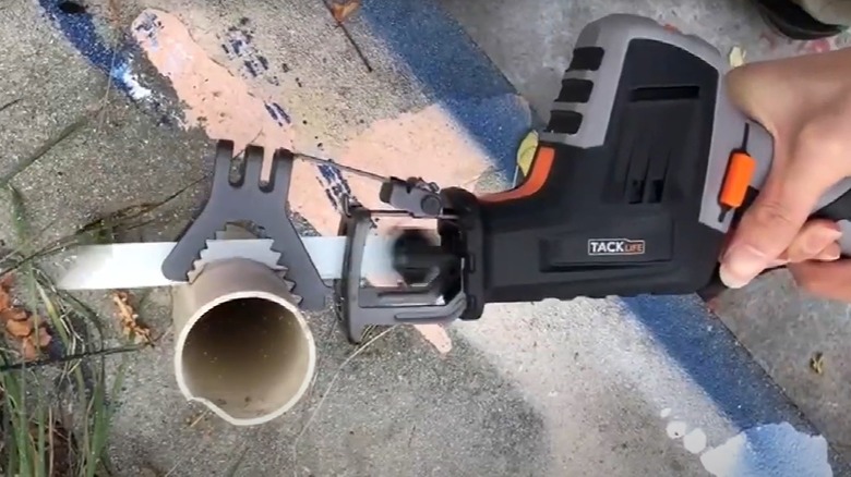 person using Tacklife reciprocating saw