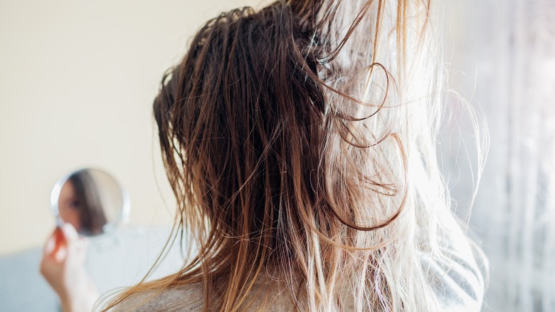 Woman lifting hair 