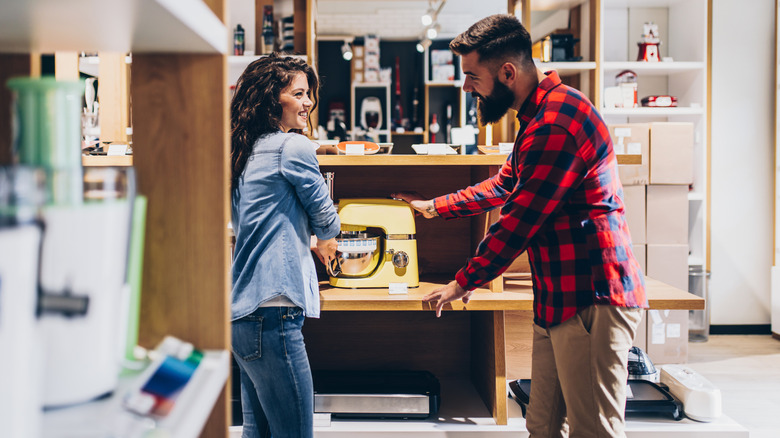 Couple shopping for KitchenAid stand mixer in store