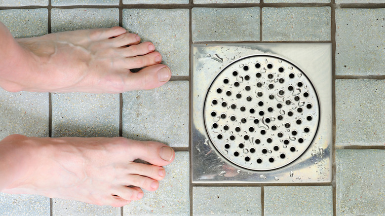 feet standing by shower drain