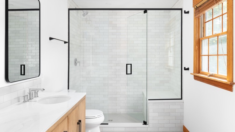 walk-in shower with white tiles