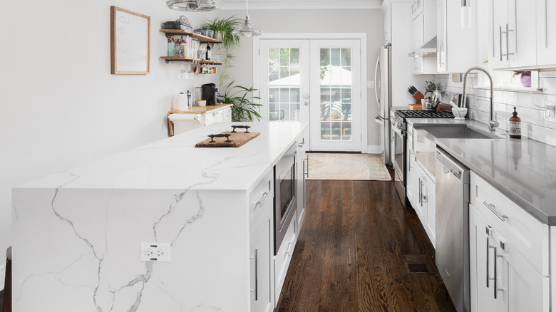 kitchen with marble waterfall counters on island