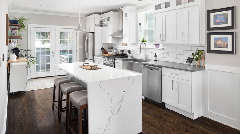 kitchen with white and gray marble waterfall island