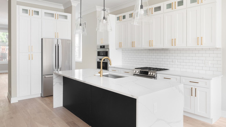 white kitchen with marble waterfall countertops