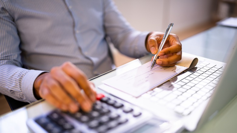 person writing a check