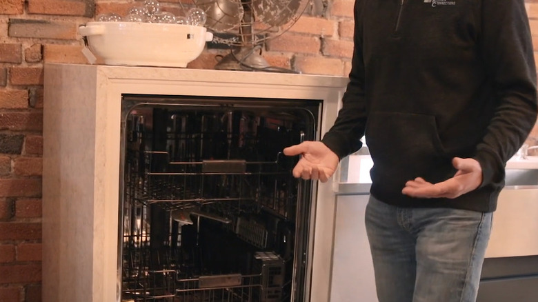 Man displaying raised refridgerator