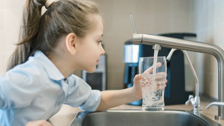 Little girl getting filtered water 