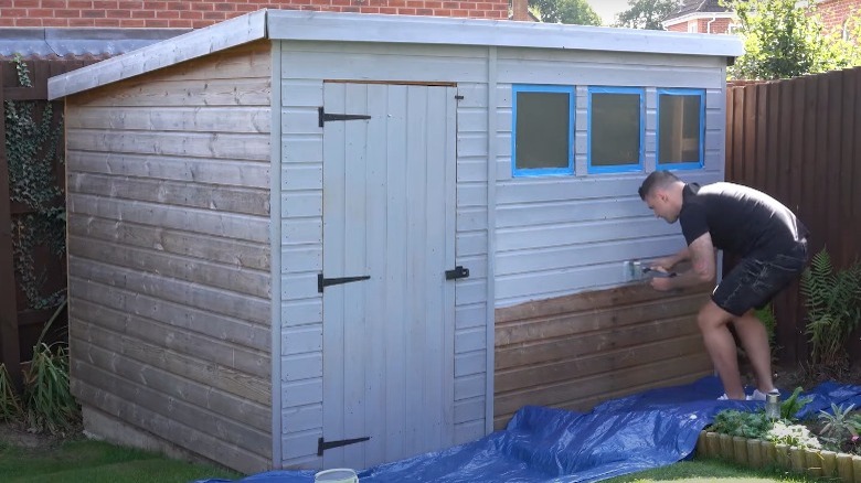 man priming shed