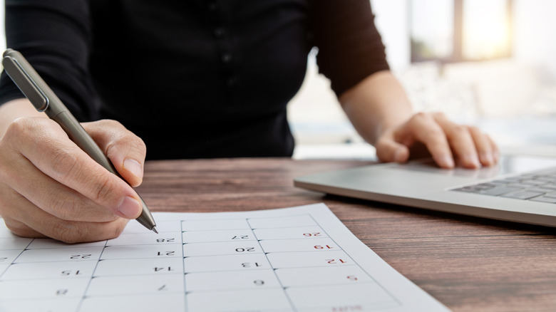 woman marking calendar