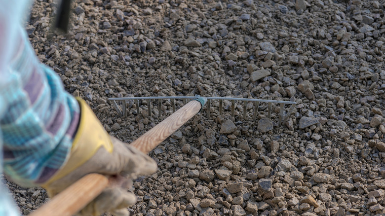 Person raking a gravel base